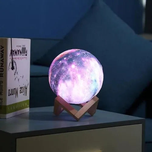galaxy moon lamp with 3D printed lunar surface glowing on a nightstand in a dark bedroom – view 2