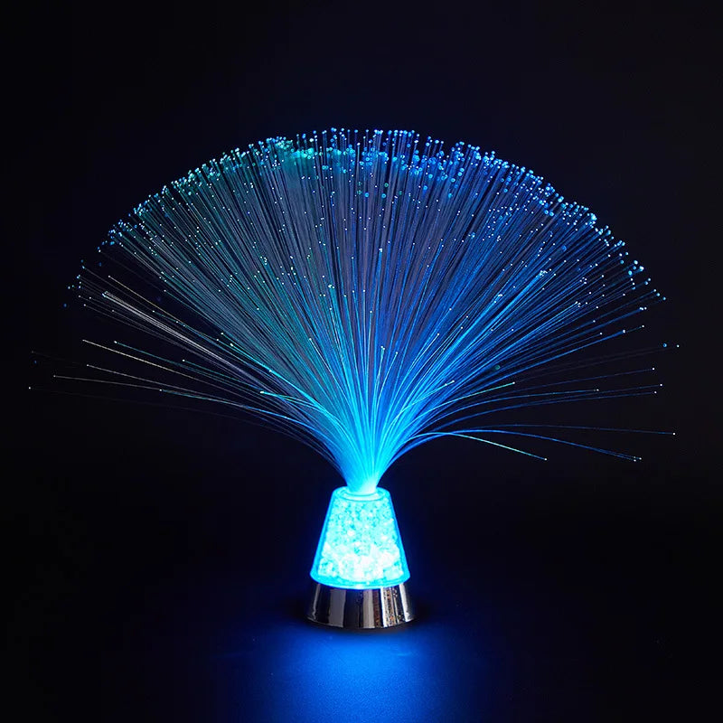 fiber optic sensory lamp with glowing color-changing strands on a nightstand in a dark room – view 3