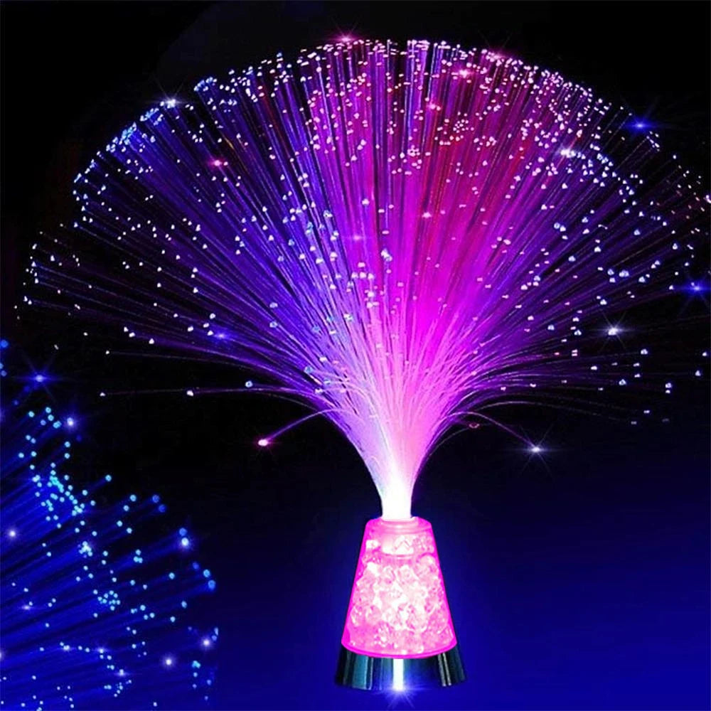 fiber optic sensory lamp with glowing color-changing strands on a nightstand in a dark room