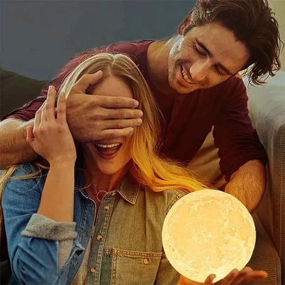 mini 3D moon lamp glowing warm on a small wooden stand beside a bed at night – view 5
