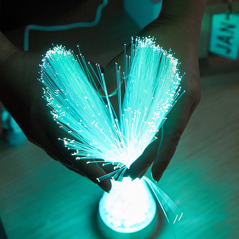 fiber optic sensory lamp with glowing color-changing strands on a nightstand in a dark room – view 4